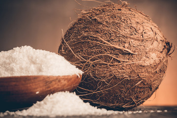 Close up of a coconut and grounded coconut flakes