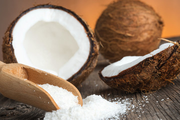 Close up of a coconut and grounded coconut flakes