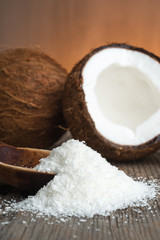 Close up of a coconut and grounded coconut flakes