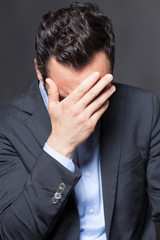 Depressed man on black background