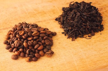 Heap of coffe grains on wooden board