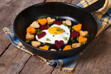 Fried egg in form heart and hearts, carrots, beets and potatoes