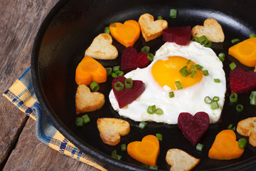 Romantic breakfast of fried eggs and vegetables of heart