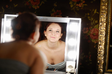 Fototapeta na wymiar Young beautiful woman at a make-up studio