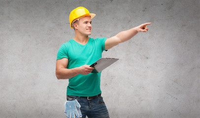 smiling man in helmet with clipboard