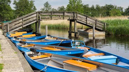 Fototapeta na wymiar Boats to hire for a trip through the canals in Giethoorn Holland