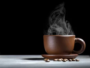 Foto auf Acrylglas Kaffee Bar Steaming coffee cup on dark background