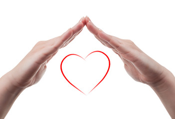 Fototapeta premium Female hands protecting a heart shape on white background