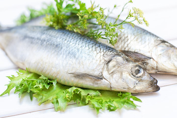 Salted herring on a white wooden table