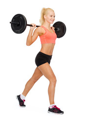 smiling sporty woman exercising with barbell