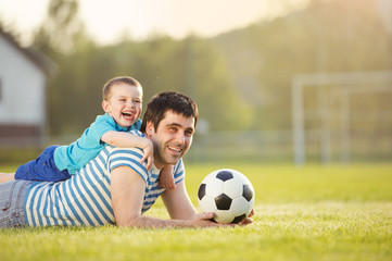 Father and son playing football