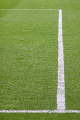 Fototapeta na wymiar White stripes on the green soccer field