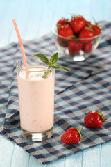 strawberry with yogurt in a glass on a wooden background