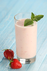 strawberry with yogurt in a glass on a wooden background