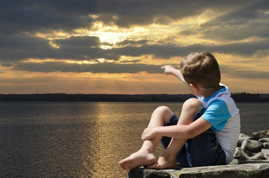 little boy meets the sunset