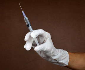 Doctor holding medical injection syringe
