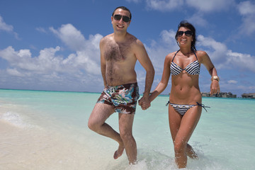 happy young couple have fun on beach