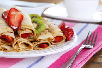 Delicious pancakes with strawberries and chocolate