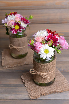 Fototapeta Beautiful bouquet of bright flowers in jars