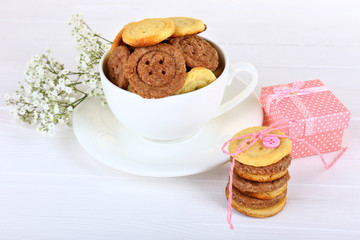 Sugar cookies in shape of buttons on table