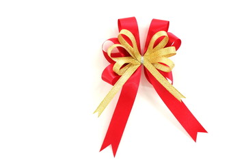 gold and red ribbon bow on white background