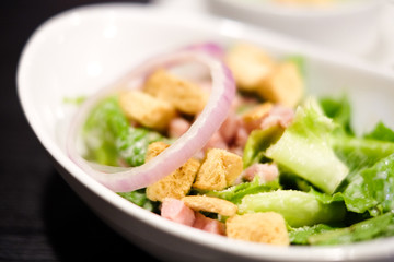 Closed up cropped bowl of caesar salad