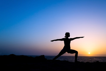 Woman training yoga pose silhouette