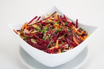 salad of fresh beets and carrots in white plate