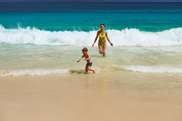 Mother and two year old boy playing on beach