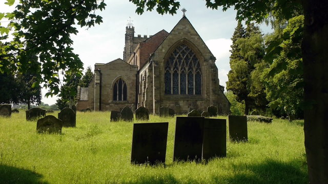Country English churchyard with gravestones.