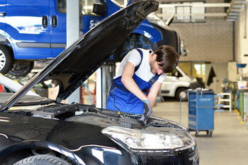 KFZ Mechaniker repariert Motor // mechanic in car workshop