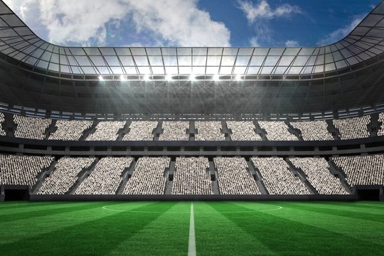 Large football stadium with white fans