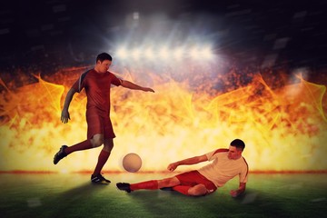 Obraz na płótnie Canvas Composite image of football players tackling for the ball