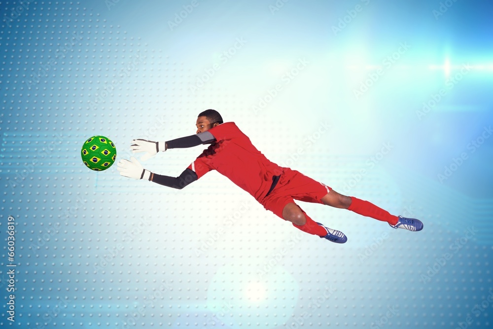 Aufkleber Composite image of goalkeeper in red making a save