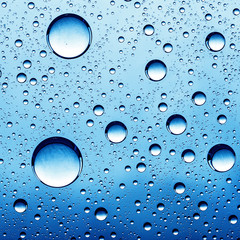 Pure oil drops over glass surface as abstract backgrounds