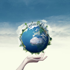 Female hand hold 3D rendered Earth globe. Environmental backgrou