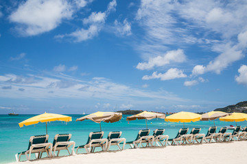 Chaise Lounges Under Umbrellas on Beach