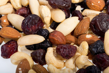 mixed nuts and dried fruits isolated on white background