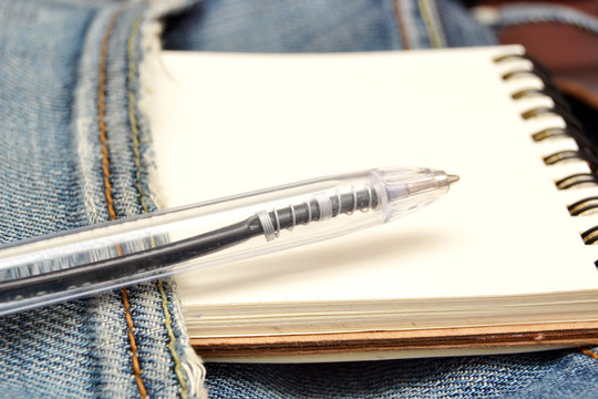 Jeans, notebook and pen
