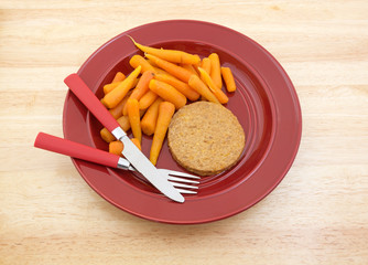 Diet meal on red plate with silverware