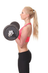 beautiful female with barbell posing on studio background