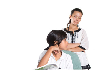 Young Asian Malay school girl studying with a female teacher