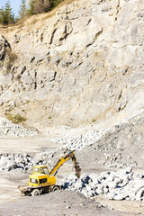 excavator loading rocks at quarry