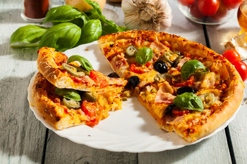Pizza with bacon, olives and jalapeno pepper