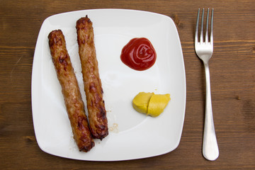Sausage with ketchup and mustard on wood