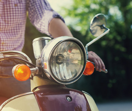 Young Man Riding Old Retro Scooter