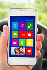 hand holding mobile phone with applications