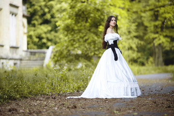 Obraz na płótnie Canvas Mysterious woman in a white Victorian dress