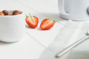 Strawberry cut in half and nuts to be served with breakfast