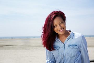 Young woman smiling at the beach